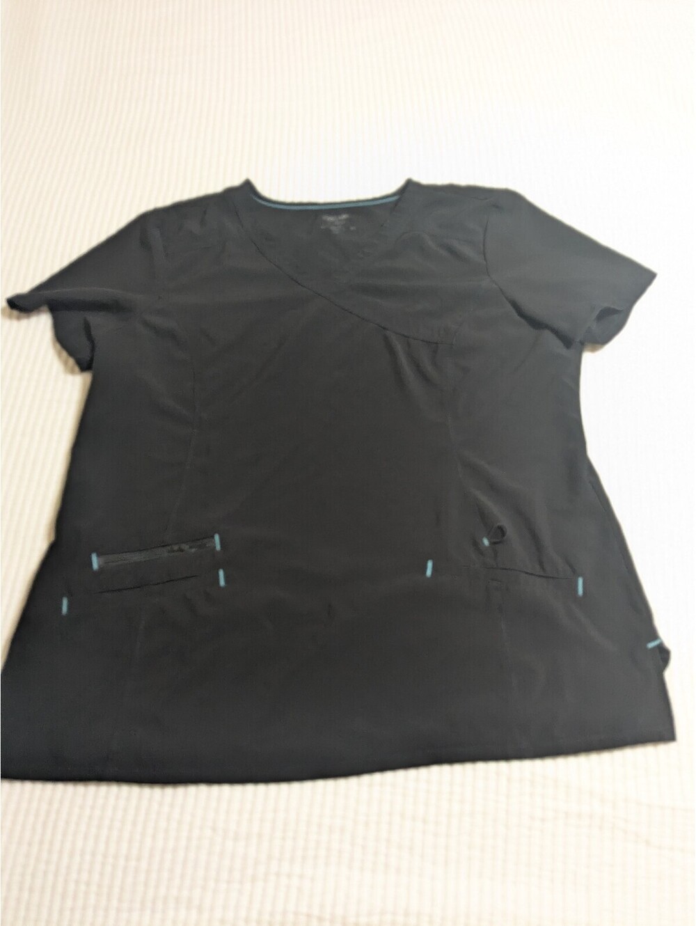 Black scrub top with teal accents